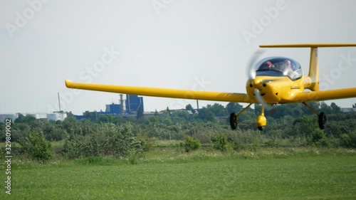 Ultralight small private aircraft airplane flying in the sky over the airfield. Aviation festival holiday at the aerodrome
