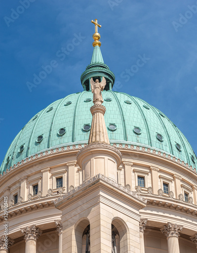 Statue of winged angel at dome of Evangelical church Saint Nikolai at blue sky, Potsdam, Germany, details, closeup