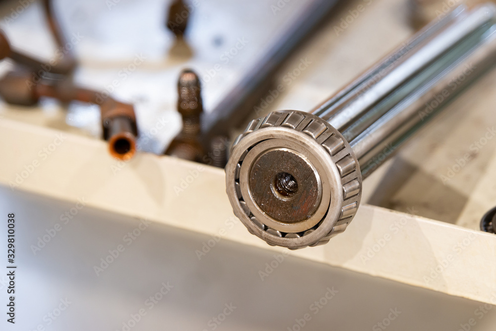 Splined shaft with bearing on the rack after the repair of the machine. Splined shaft with bearing on the rack after the repair of the machine.
