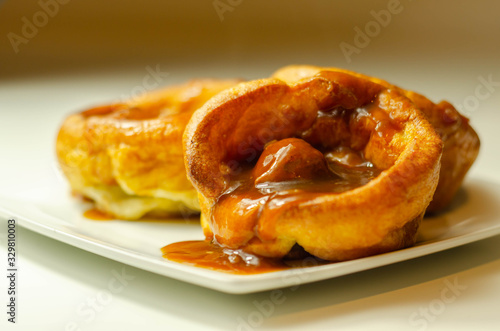 Traditional English Yorkshire pudding with meatballs and thick gravy sauce