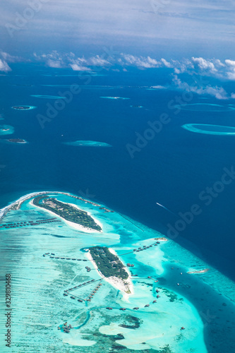 Tropical islands and atolls in Maldives from aerial view. Aerial view of Maldives island and blue ocean background