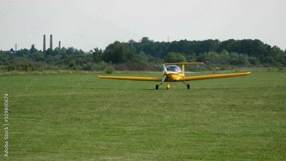 Ultralight small private aircraft airplane moving on the airfield. Aviation festival holiday at the aerodrome airport Ultralight small private aircraft airplane moving on the airfield. Aviation festival holiday at the aerodrome airport