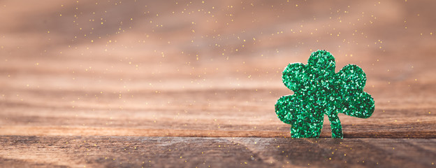 St Patrick's day background with shamrock clover leaf on wood, Irish festival symbol, selective focus