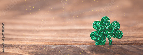 St Patrick's day background with shamrock clover leaf on wood, Irish festival symbol, selective focus