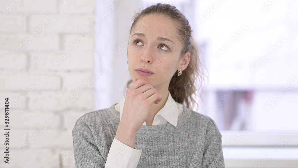 Portrait of Thoughtful Young Latin Woman Thinking in Office Portrait of Thoughtful Young Latin Woman Thinking in Office