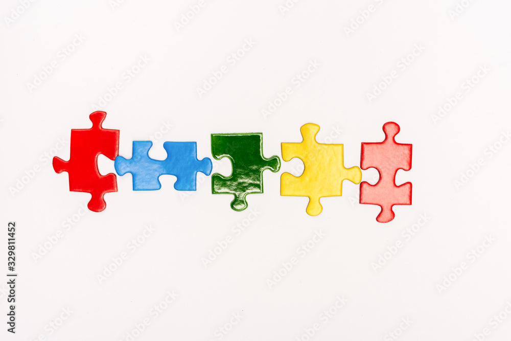 Top view of bright pieces of puzzle isolated on white, autism concept Top view of bright pieces of puzzle isolated on white, autism concept