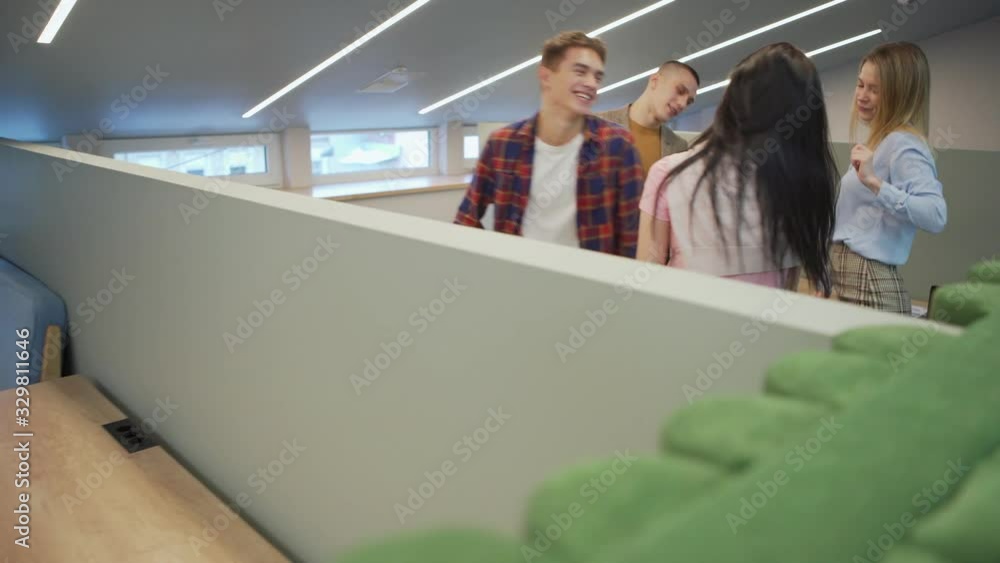 Tracking shot of happy diverse business team of four young people enjoying dancing together at cubicle Tracking shot of happy diverse business team of four young people enjoying dancing together at cubicle