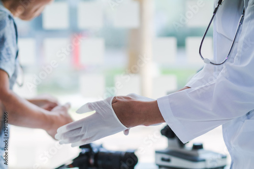 Wallpaper Mural Medical scientists are wearing coronavirus protective clothing and rubber gloves before entering the lab for examination of coronavirus. covid-19 and research for a vaccine against coronavirus covid19 Torontodigital.ca