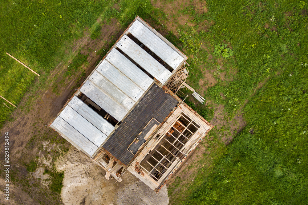 Aerial view of building site for future brick house, concrete foundation floor and stacks of yellow clay bricks for construction. Aerial view of building site for future brick house, concrete foundation floor and stacks of yellow clay bricks for construction.