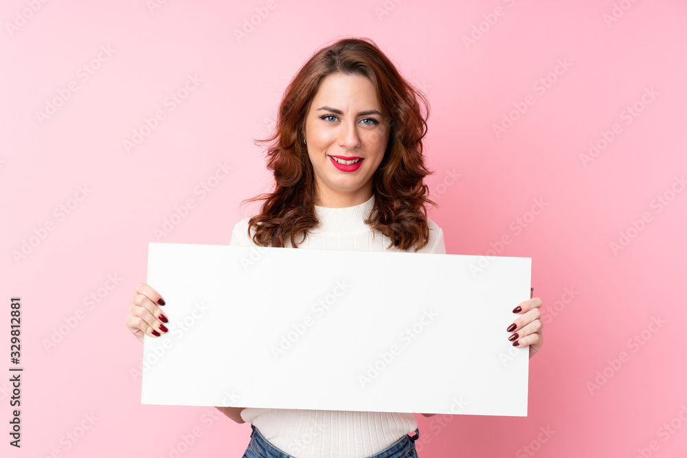 Young Russian woman over isolated pink background holding an empty white placard for insert a concept Young Russian woman over isolated pink background holding an empty white placard for insert a concept