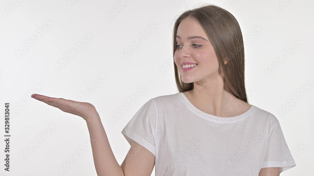 Young Woman Showing Product on Hand, White Background Young Woman Showing Product on Hand, White Background