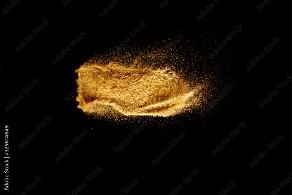 Fototapeta premium Brown colored sand splash.Dry river sand explosion isolated on black background. Abstract sand cloud.