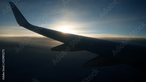 Wing of the plane airplane airliner aircraft in the beautiful sunny morning sky. Aviation tourist flights by air 