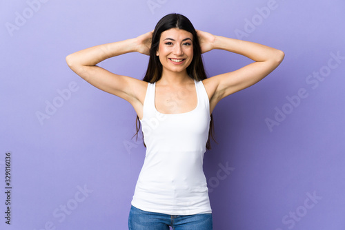Young brunette woman over isolated purple background laughing © luismolinero