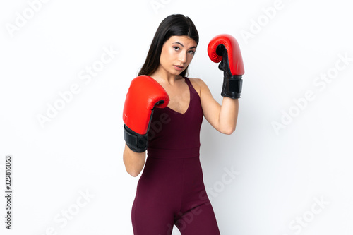 Young sport woman over isolated white background with boxing gloves