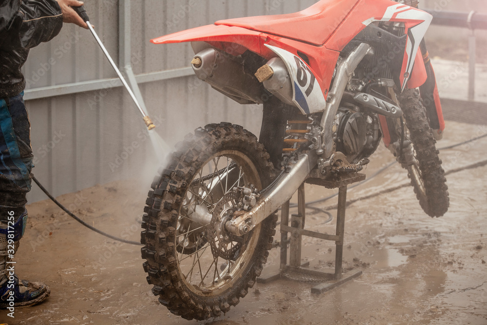 Crossbike washing after the competition. Washing dirty wheel of