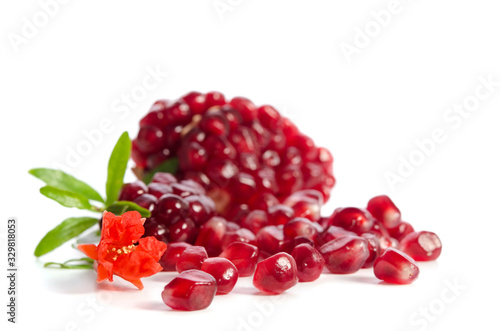 Parts of a pomegranate with pomegranate seeds and leaves, flowers isolated on white background