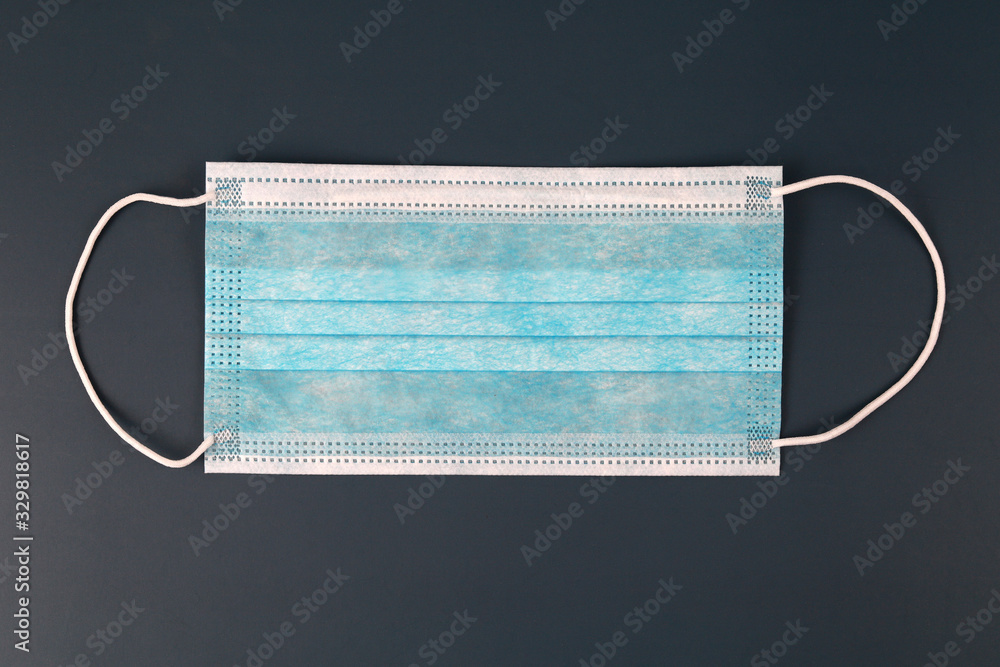 Surgical ear-loop mask on dark background. Surgical ear-loop mask on dark background.