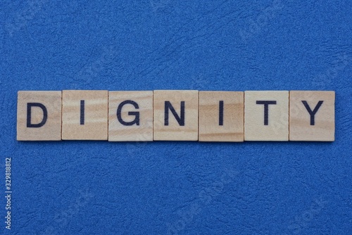 Fototapeta word dignity from small gray wooden letters lies on a blue background