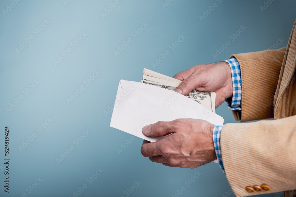 money in a hand over blue background, toned imagee money in a hand over blue background, toned imagee