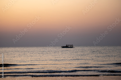 boat on Mediterranean sea at sunrise