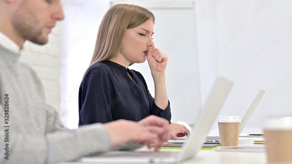 Creative Woman Working on Laptop and Coughing in Office Creative Woman Working on Laptop and Coughing in Office