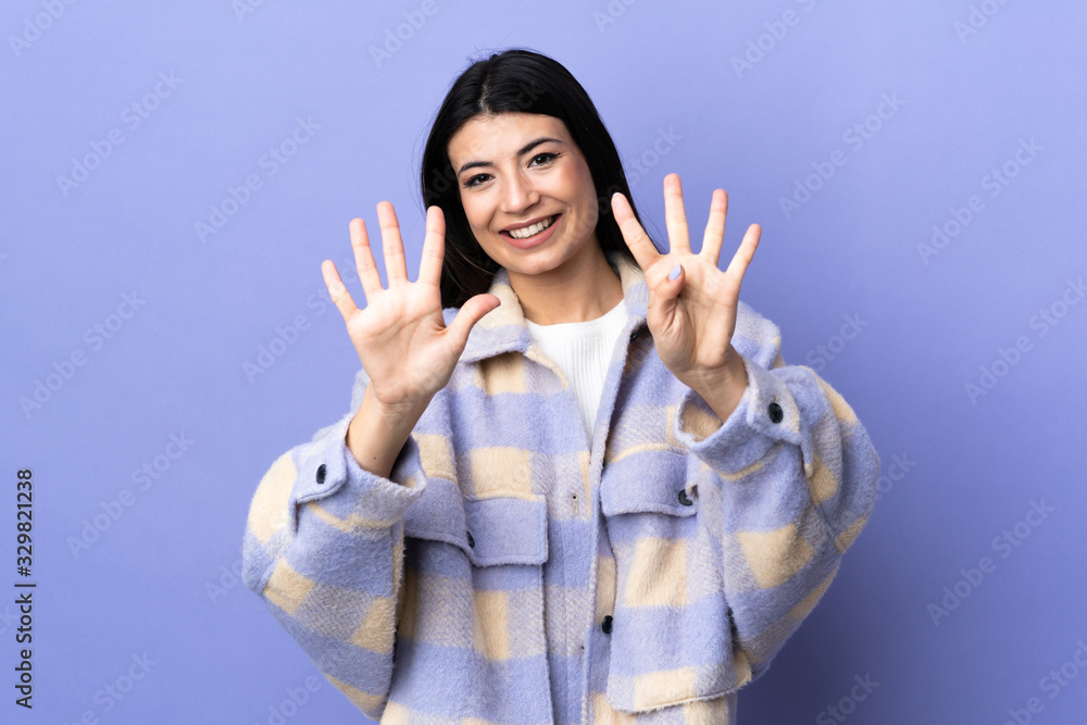 Young brunette woman over isolated purple background counting nine with fingers Young brunette woman over isolated purple background counting nine with fingers