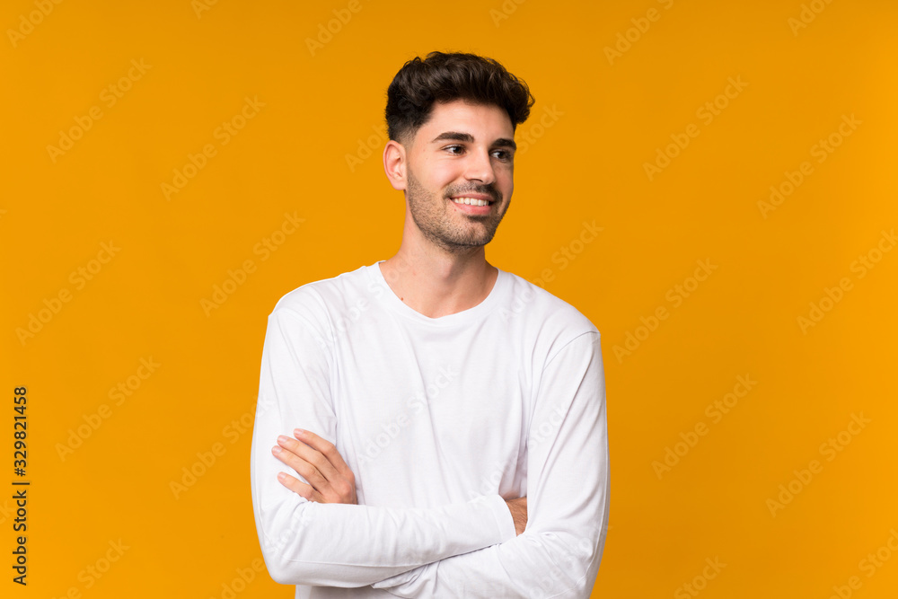 Young man over isolated orange background happy and smiling Young man over isolated orange background happy and smiling
