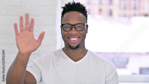 Portrait of Casual African Man Waving at Camera