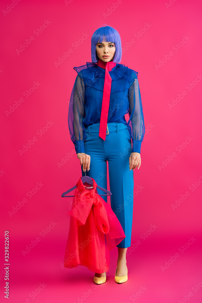 beautiful girl in purple wig holding hanger with red blouse, on pink beautiful girl in purple wig holding hanger with red blouse, on pink