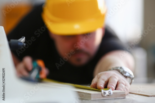 Arms of worker measuring wooden bar closeup. Manual job DIY inspiration improvement job fix shop yellow helmet joinery startu, workplace idea designer career ruler industrial education