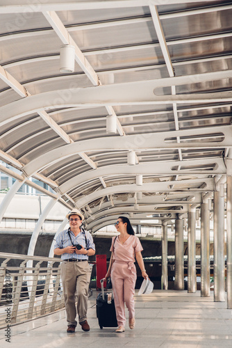 Smiling Couple Walking On Bridge In City