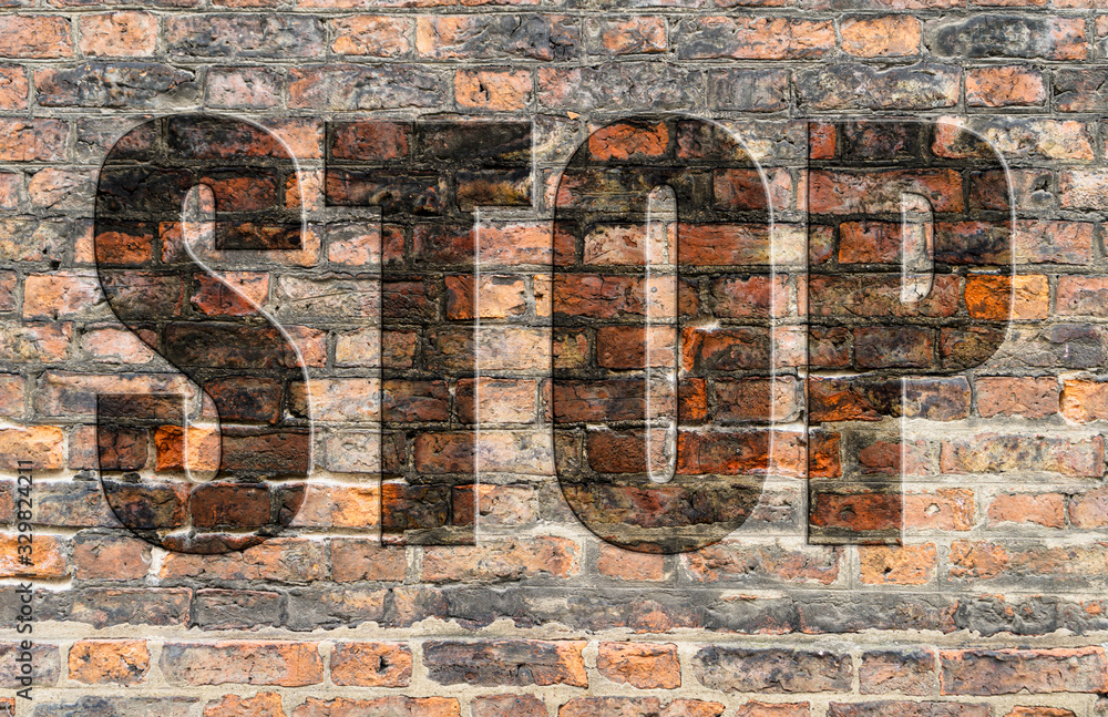 Brick wall of a ruined house in reddish and brown tones with the word Stop written in 3D. Brick wall of a ruined house in reddish and brown tones with the word Stop written in 3D.