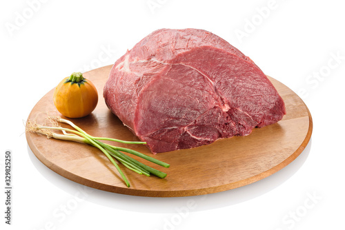 Raw beef knuckle, an exceptionally lean cut from the round, between the top round and bottom round, ready to be cooked. On a cutting board, isolated on white background