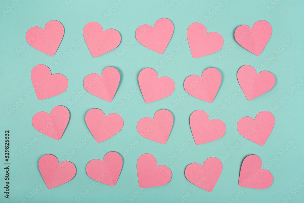 Flat lay of pink paper heart cards on blue background. Abstract hearts paper cut out concept. Flat lay of pink paper heart cards on blue background. Abstract hearts paper cut out concept.