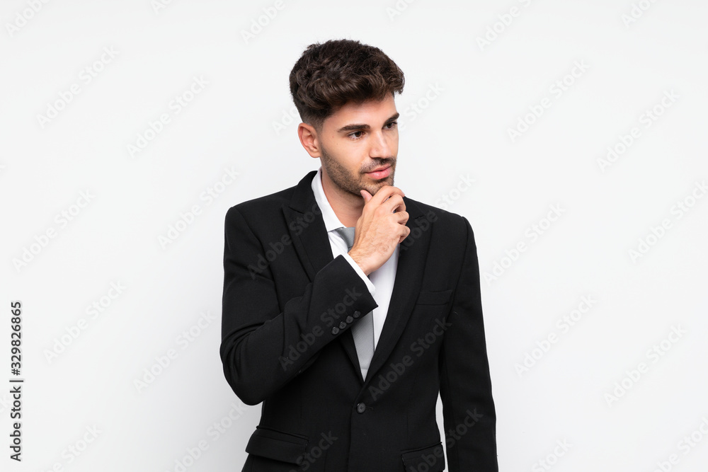Young businessman over isolated white background thinking an idea Young businessman over isolated white background thinking an idea