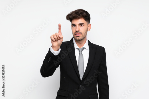Young businessman over isolated white background touching on transparent screen