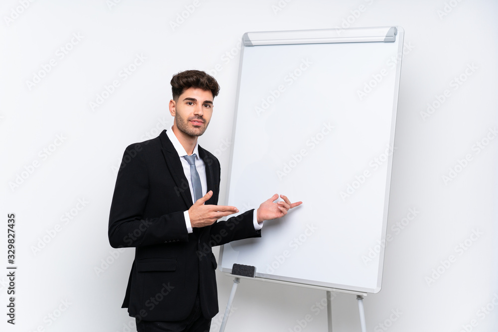 Young businessman giving a presentation on white board giving a presentation on white board Young businessman giving a presentation on white board giving a presentation on white board