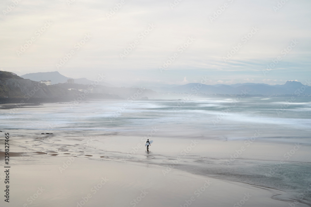 Surfer looking for the waves in the beach, Biarritz, Pyrenees Atlantiques, Aquitaine, France