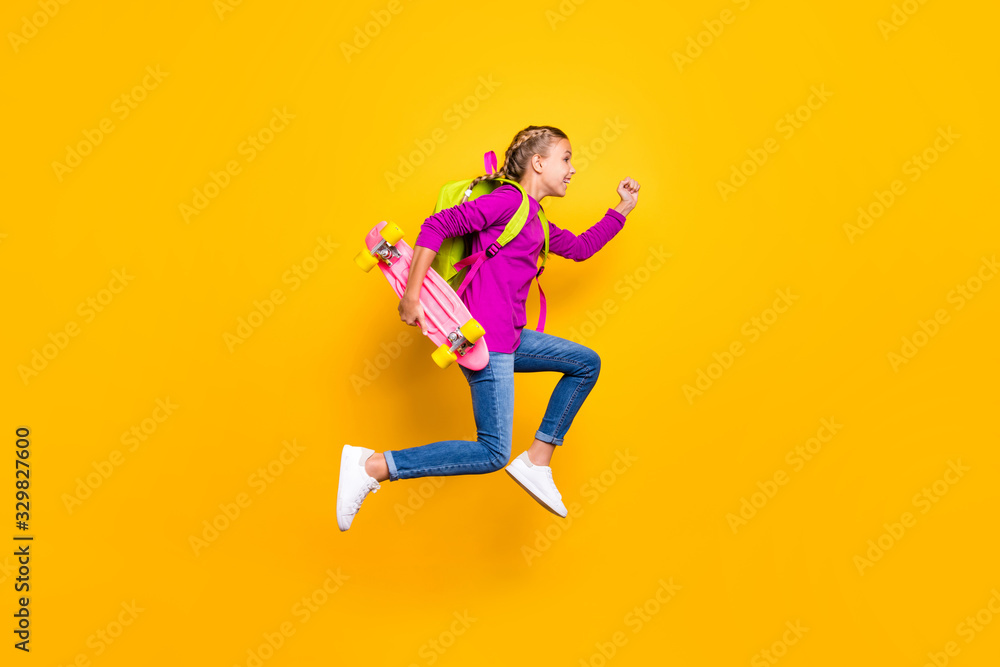 Full length body size view of her she nice attractive lovely glad purposeful cheerful cheery girl jumping running isolated over bright vivid shine vibrant yellow color background
