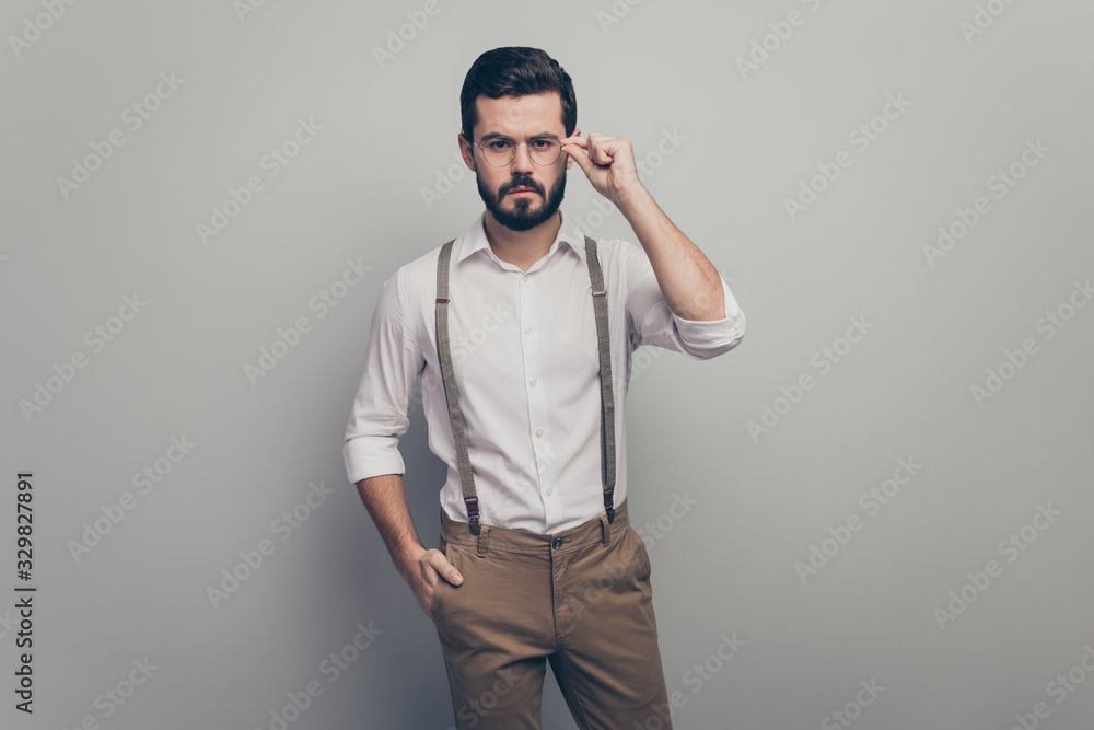 Portrait of strict stunning elegant macho man successful rich wealthy lawyer touch spectacles wear modern clothes isolated over grey color background Portrait of strict stunning elegant macho man successful rich wealthy lawyer touch spectacles wear modern clothes isolated over grey color background