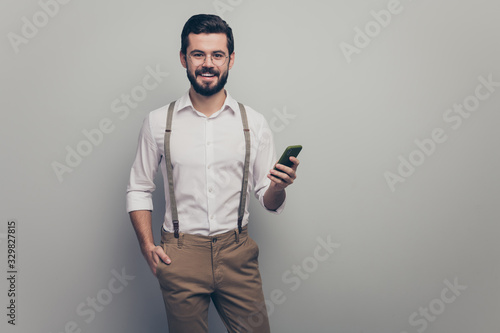 Portrait of positive successful executive gentleman worker use smartphone read social network work blogger information wear white pants trousers isolated over grey color background
