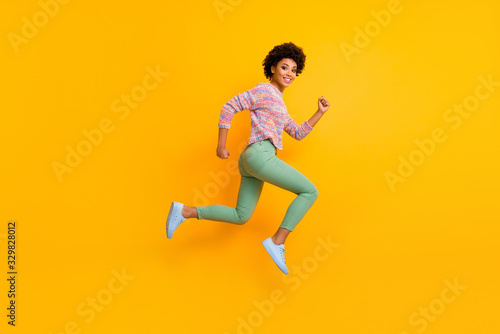 Full length profile side photo of funky dreamy cheerful afro american girl jump run hurry want black friday discount wear green good fall spring outfit isolated over shine color background