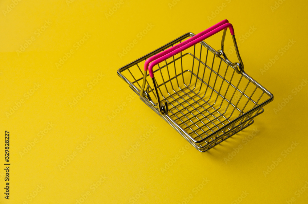 Shopping basket on a yellow background. Supermarket food price concept. Shopping basket on a yellow background. Supermarket food price concept.