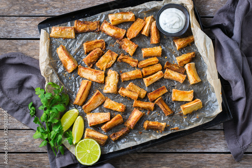 Fried yucca, yuca, cassava, manioca, mandioca with cilantro sauce photo