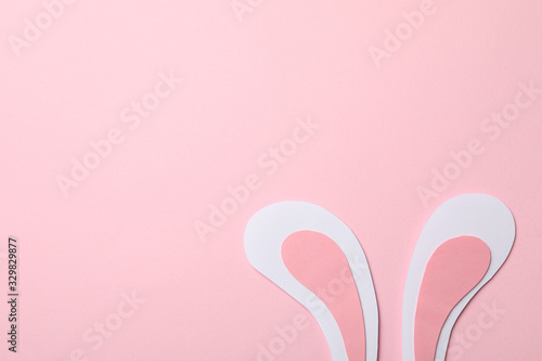 Decorative bunny ears on pink background, space for text