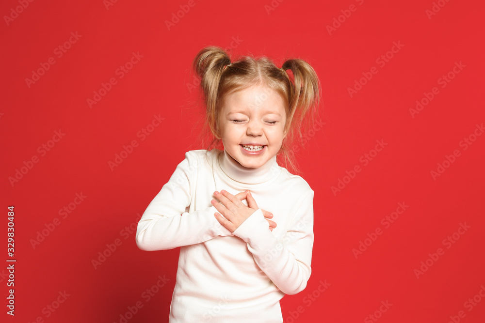 Portrait of cute little girl on red background Portrait of cute little girl on red background
