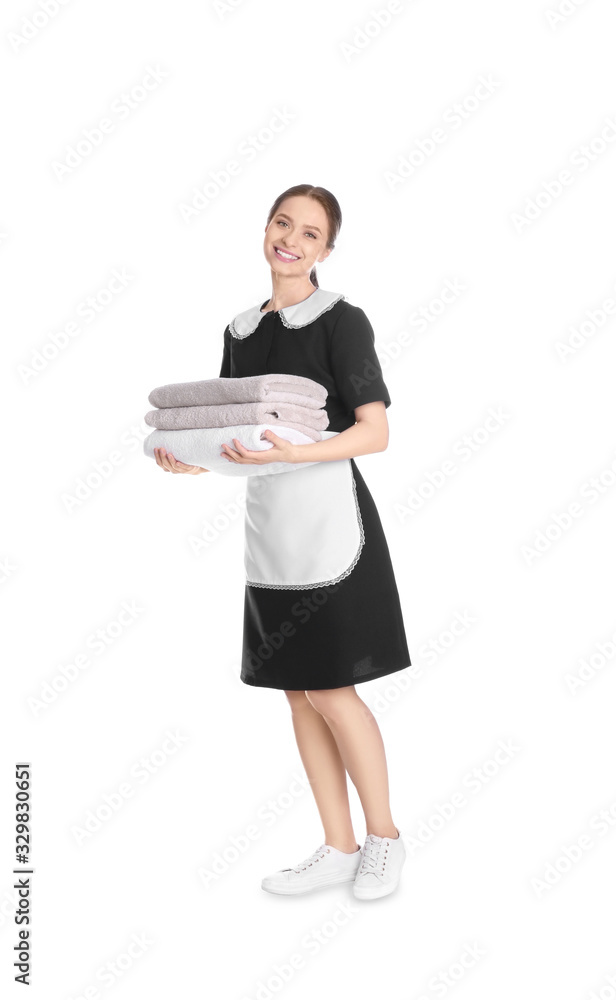 Young chambermaid holding stack of fresh towels on white background Young chambermaid holding stack of fresh towels on white background