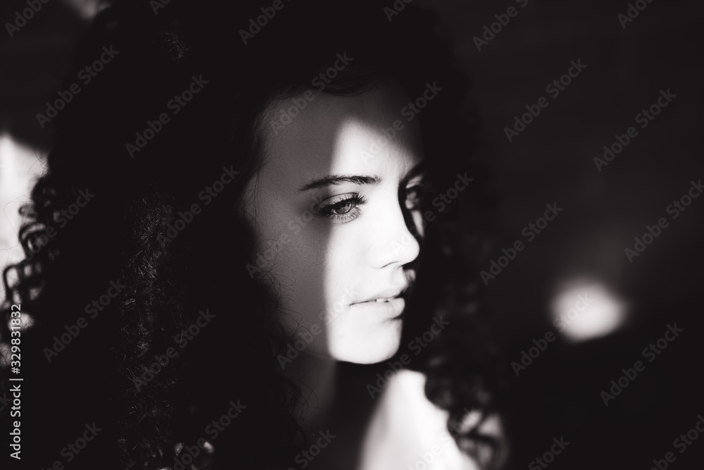 beautiful curly girl posing on camera, black and white, hard sun light beautiful curly girl posing on camera, black and white, hard sun light