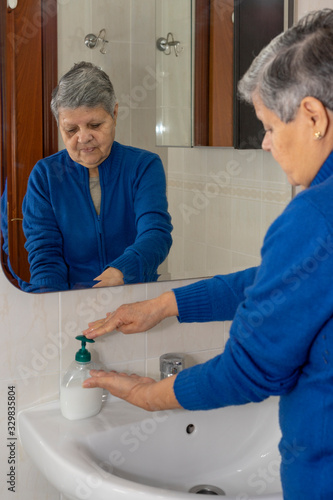 Old lady washing her hands properly to avoid contagious illnesses like the flu  colds.